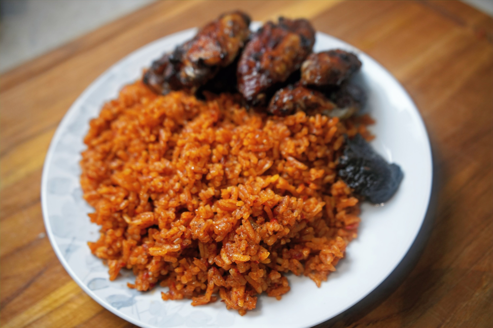 ghana jollof rice served with chicken wings