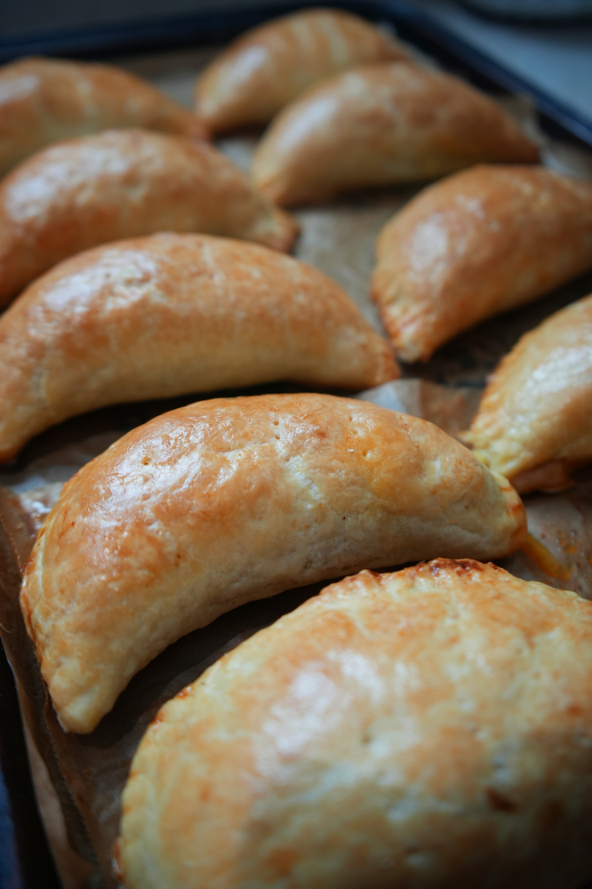 a tray of Nigerian chicken pies laid out on a tray