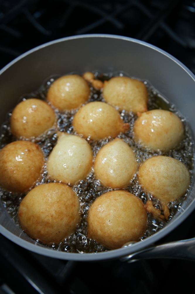 puff puff frying in a pot of hot oil