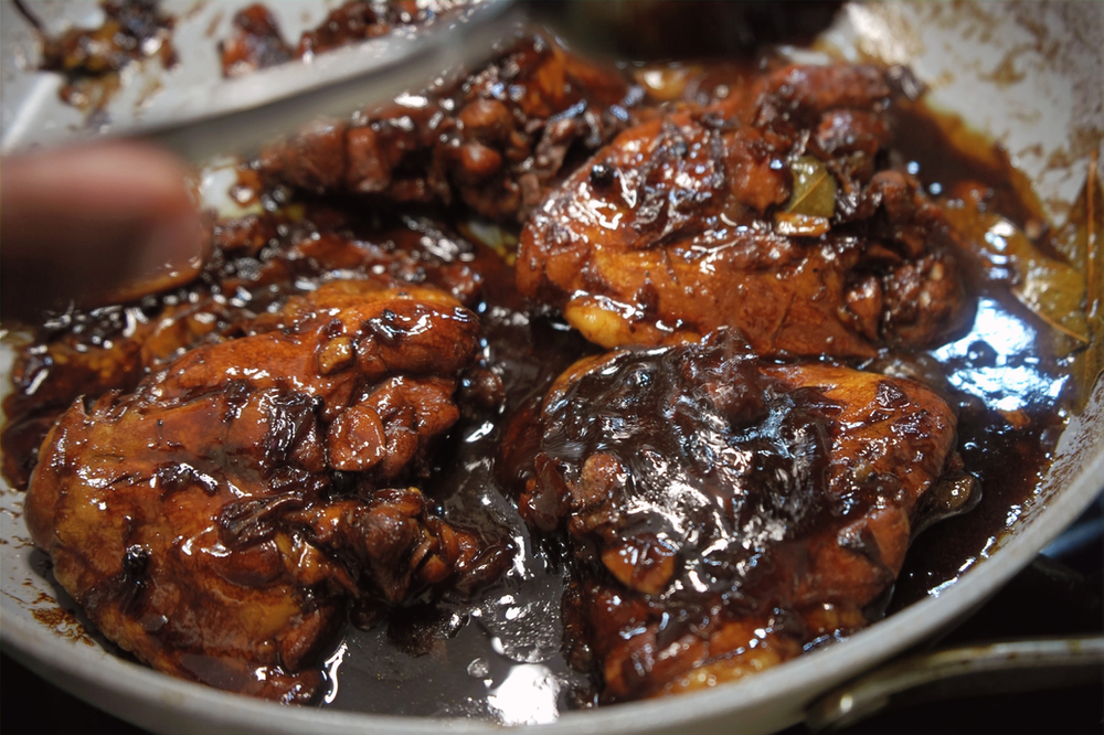 filipino chicken adobo in a hot skillet