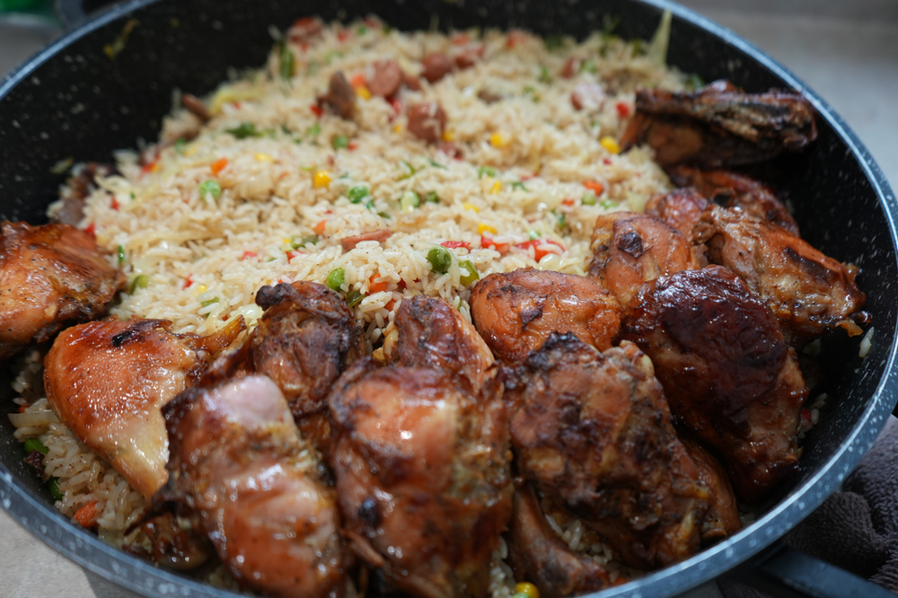 Nigerian fried rice served with fried chicken