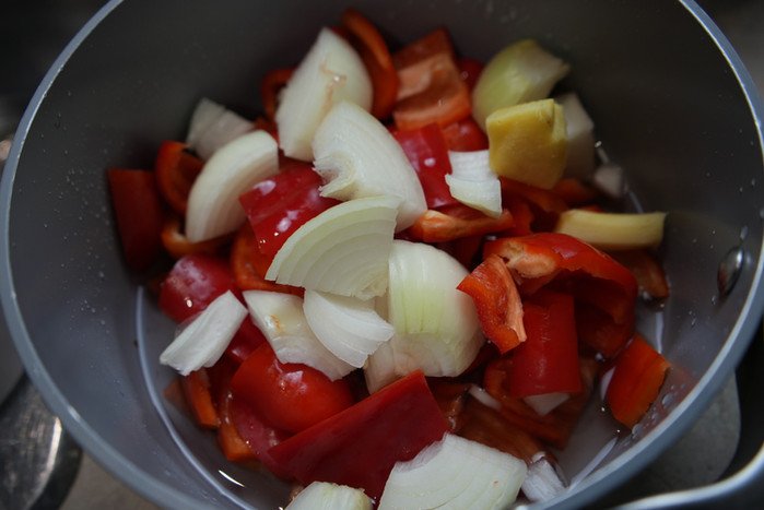 cut up bell peppers, scotch bonnets, onions and ginger