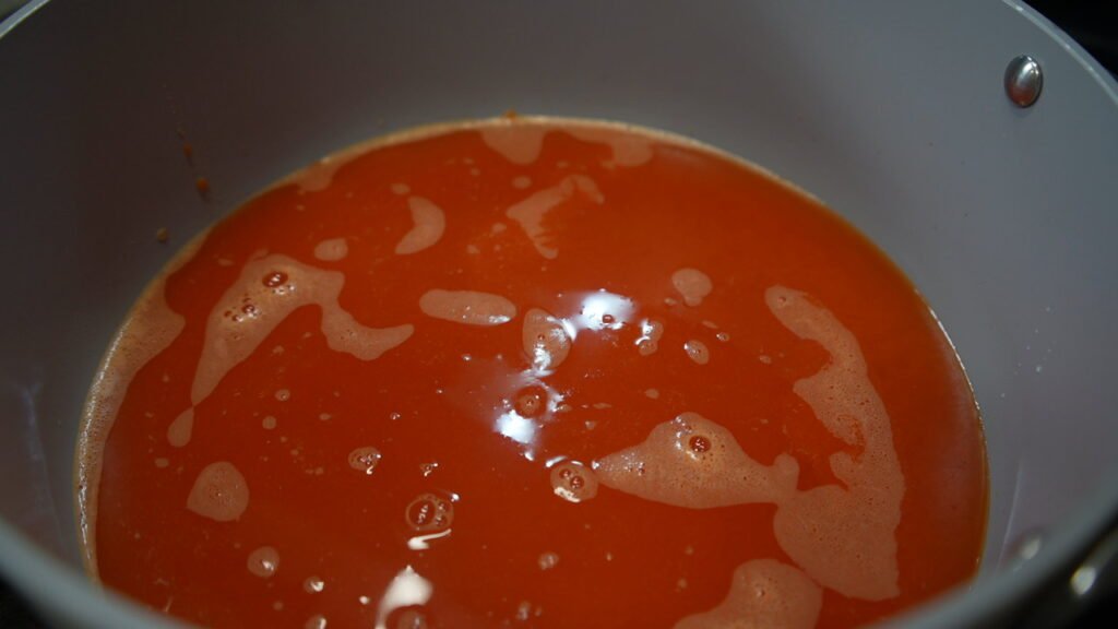 Strained pepper soup cooking in a deep pot