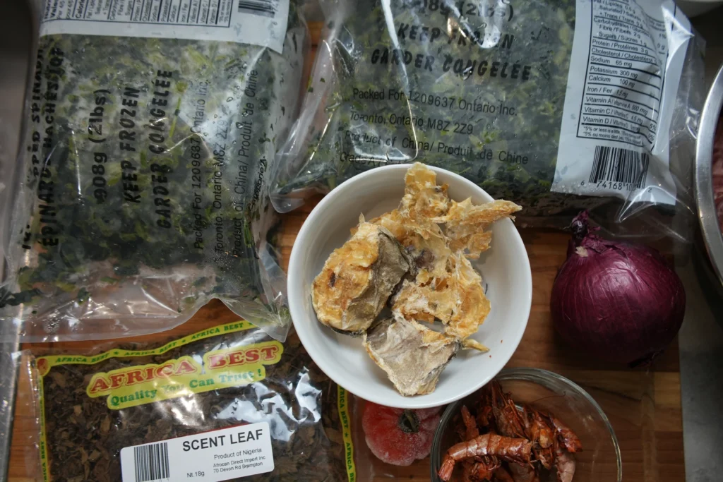 dried cod in white bowl, chopped spinach, dried shrimp, onion and dried scent leaves