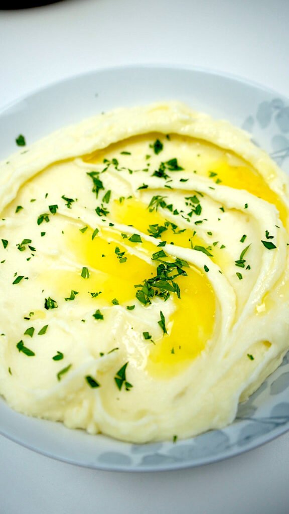 creamy french-style mashed potatoes with some melted butter and chopped parsley