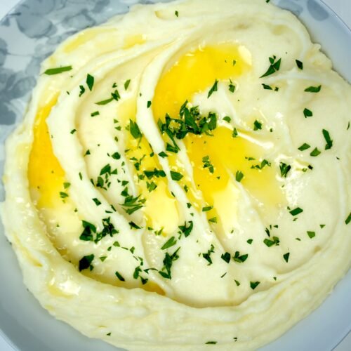 mashed potatoes wirh melted butter and garnished with chopped parsley