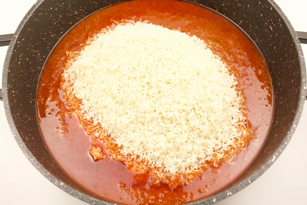 Mixing Rice into Jollof Rice Sauce