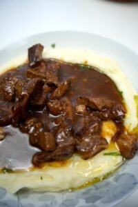 beef in gravy served on mashed potatoes