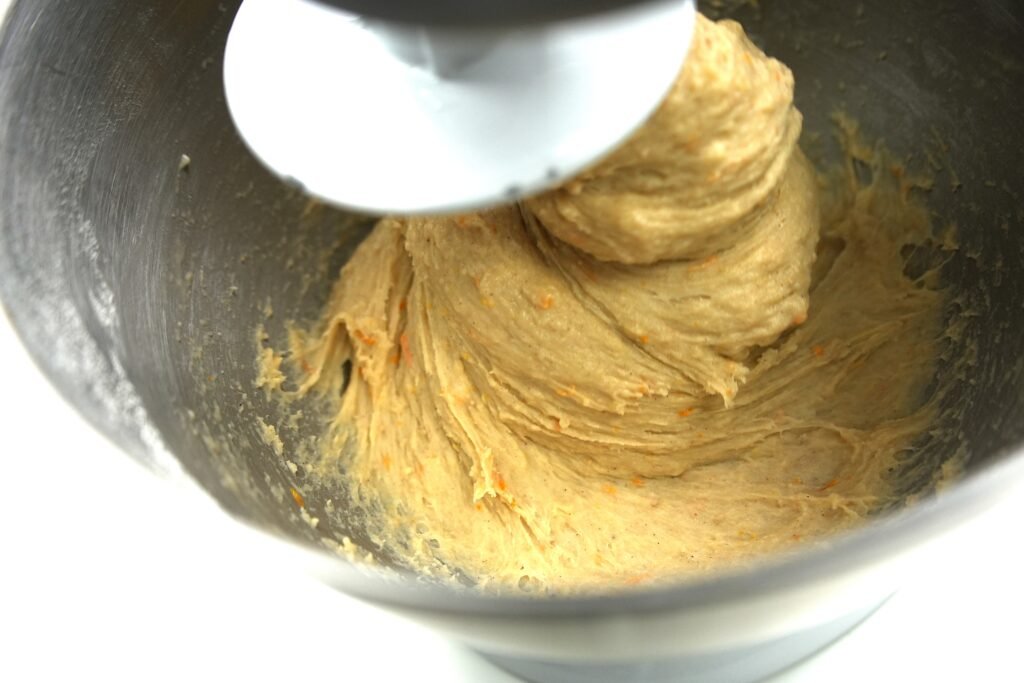 dough being kneaded in a stand mixer