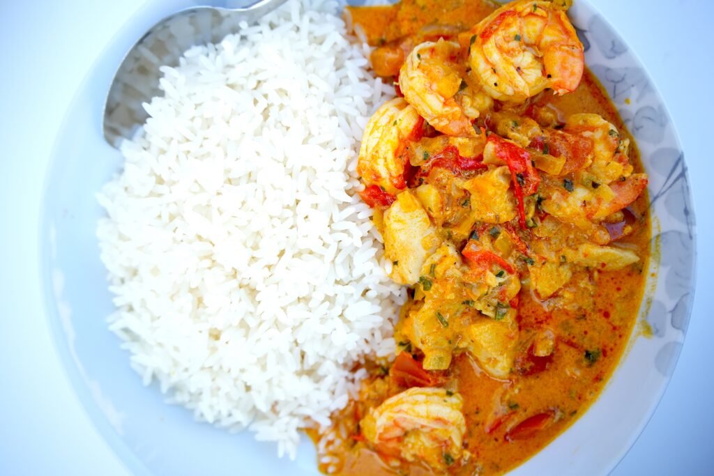 a serving of white rice and moqueca stew