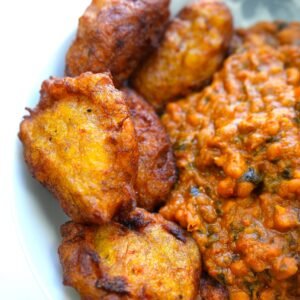 plate of bean stew served with kaaklo plantain balls