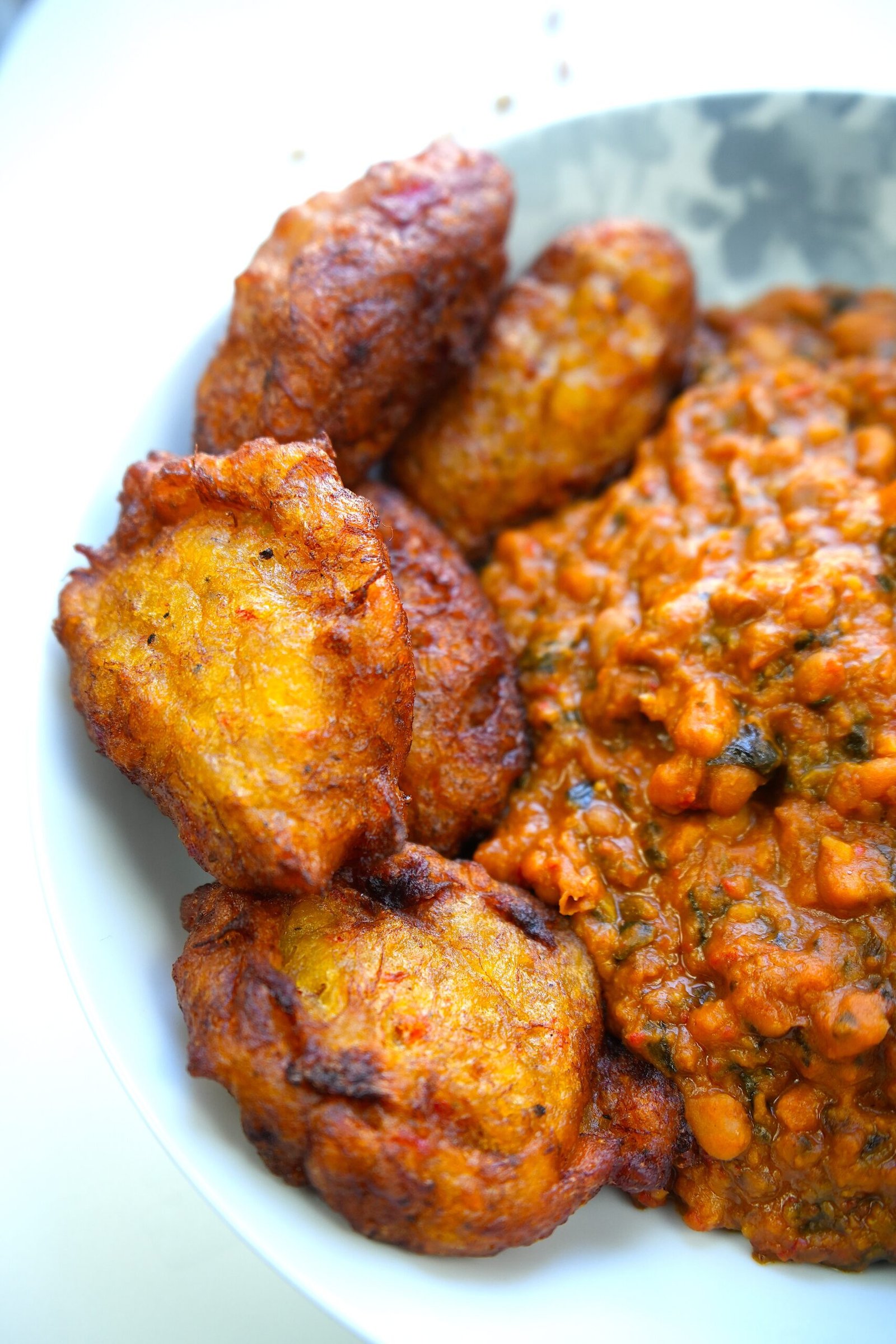 plate of bean stew served with kaaklo plantain balls